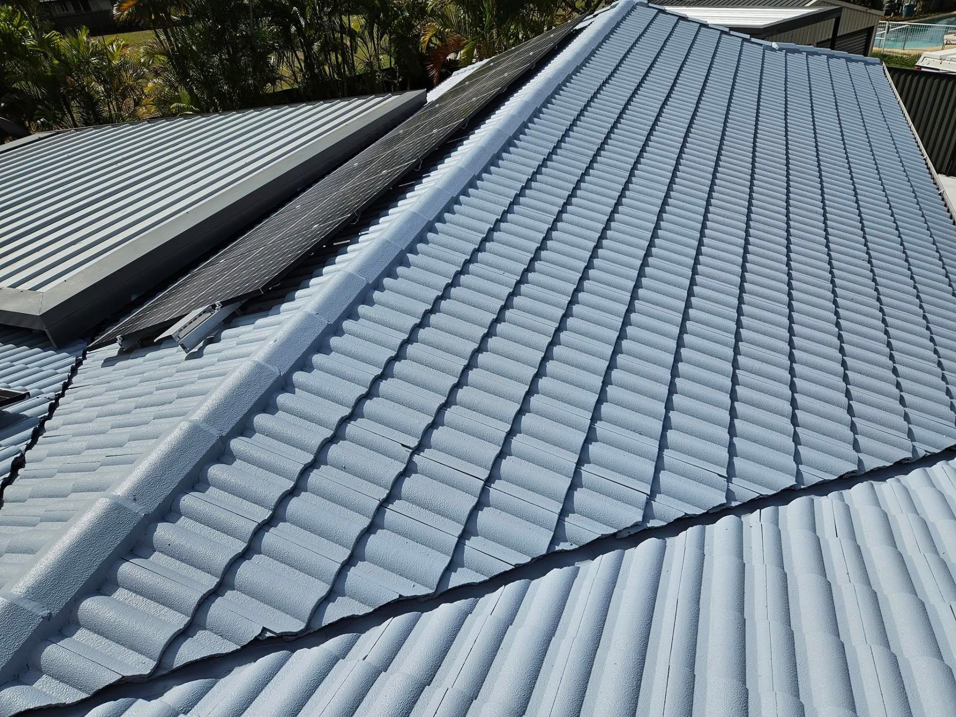 Freshly sealed grey tile roof close-up